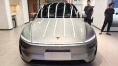 Tesla profits slide despite record revenue