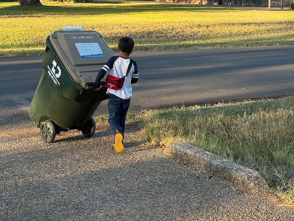 I don’t give my 7-year-old an allowance. Instead, he runs a neighborhood business, where neighbors pay him to take out their trash.